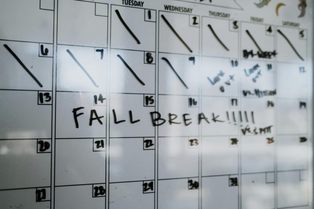 Close-up of a whiteboard calendar with 'FALL BREAK' written in bold letters.